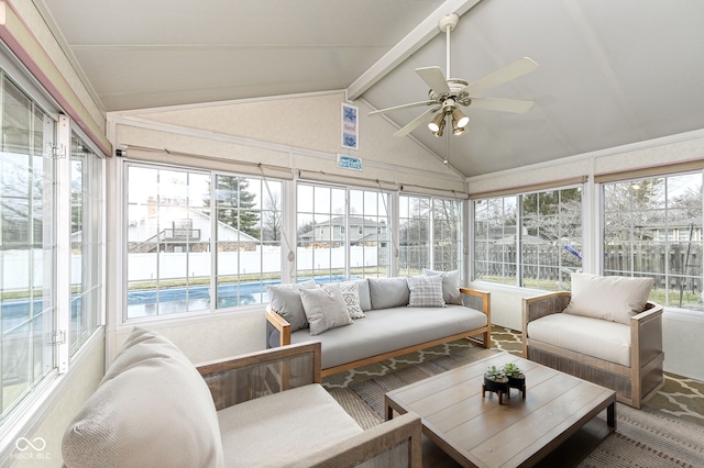 sunroom featuring vaulted ceiling with beams, a healthy amount of sunlight, and ceiling fan