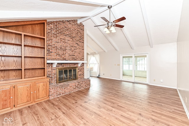 unfurnished living room featuring baseboards, ceiling fan, light wood-type flooring, a brick fireplace, and beam ceiling