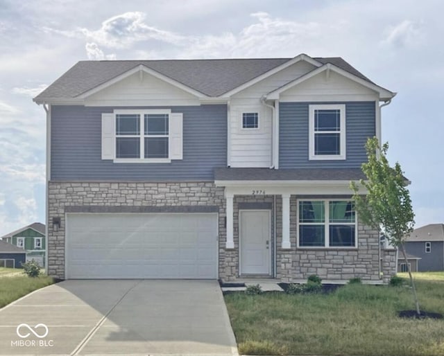 view of front of property with driveway, an attached garage, and a front lawn