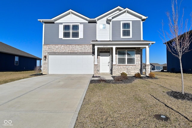 view of front facade featuring stone siding, covered porch, driveway, and a garage