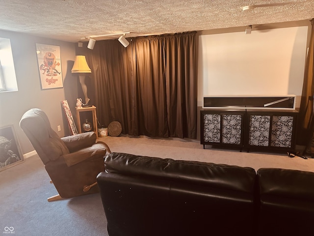 cinema with a textured ceiling, carpet flooring, and rail lighting