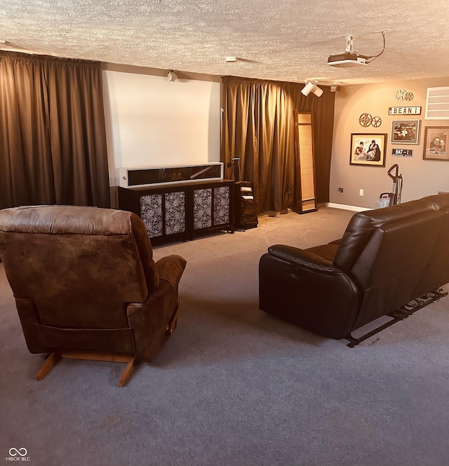 home theater room with a textured ceiling and carpet floors