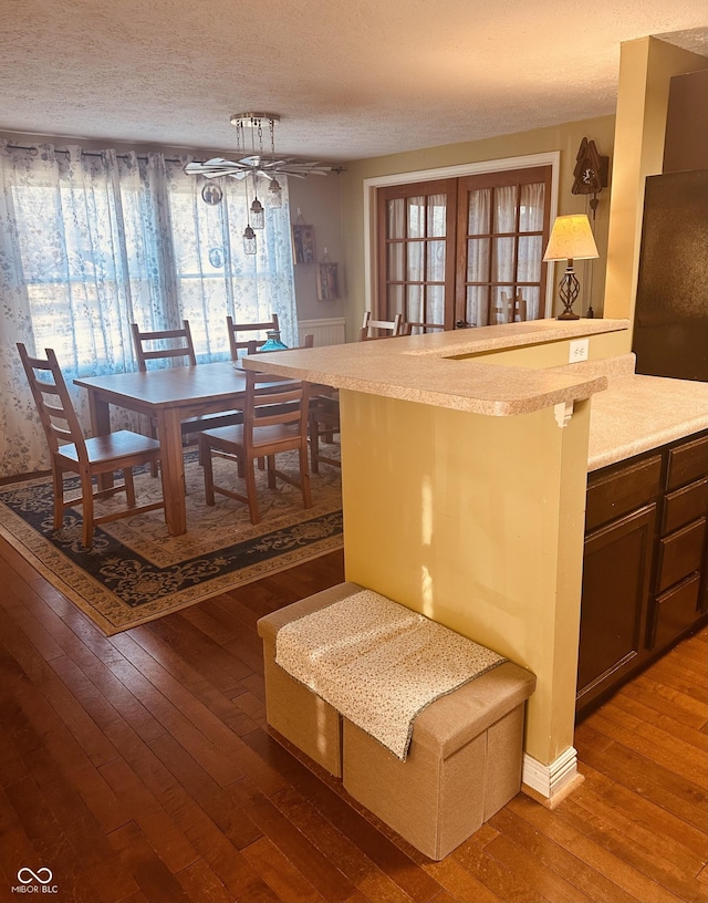 interior space featuring hardwood / wood-style flooring and a textured ceiling