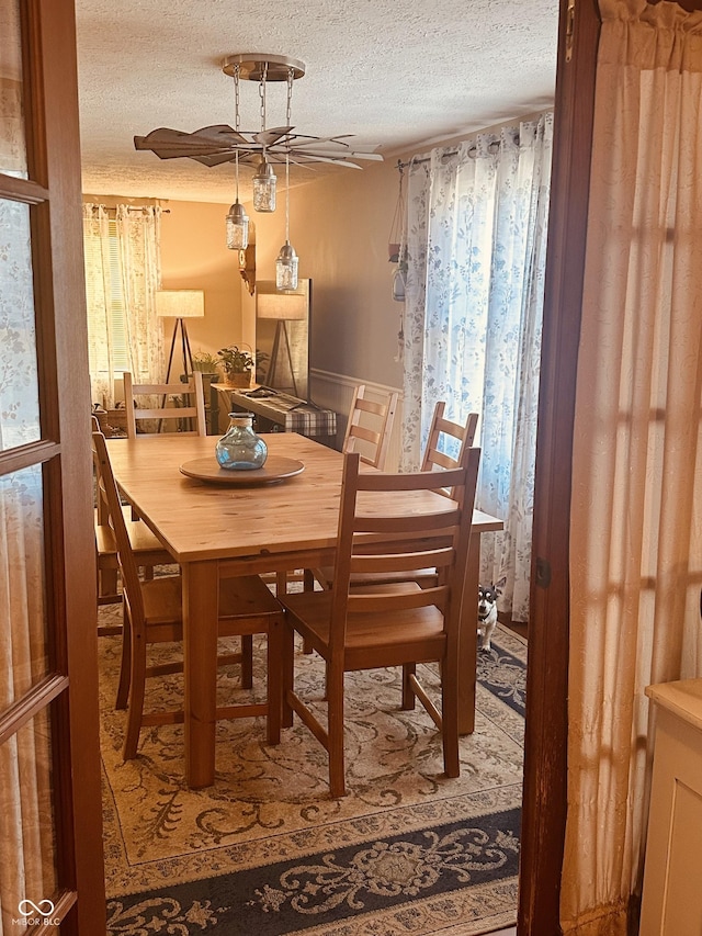 dining space with a textured ceiling