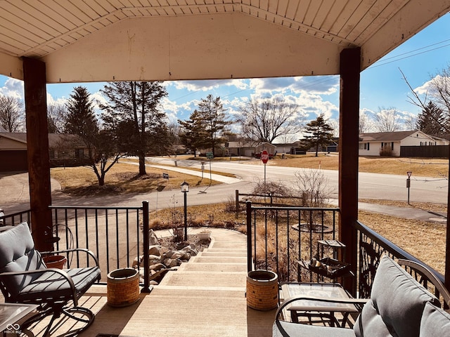 wooden terrace featuring covered porch