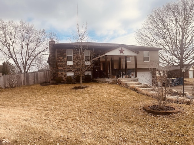 view of front of house featuring a garage, brick siding, fence, a front lawn, and a chimney