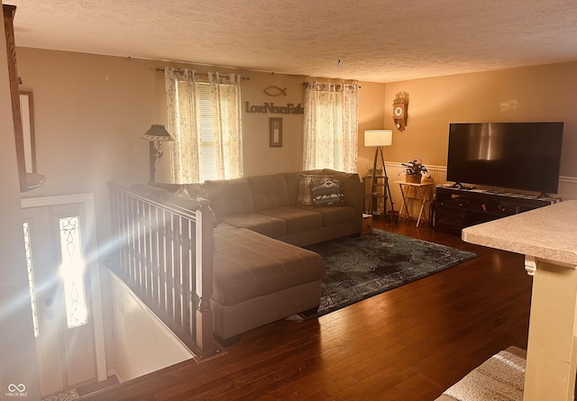 living area with hardwood / wood-style flooring and a textured ceiling