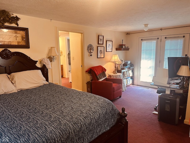 bedroom featuring a textured ceiling, carpet floors, and access to exterior