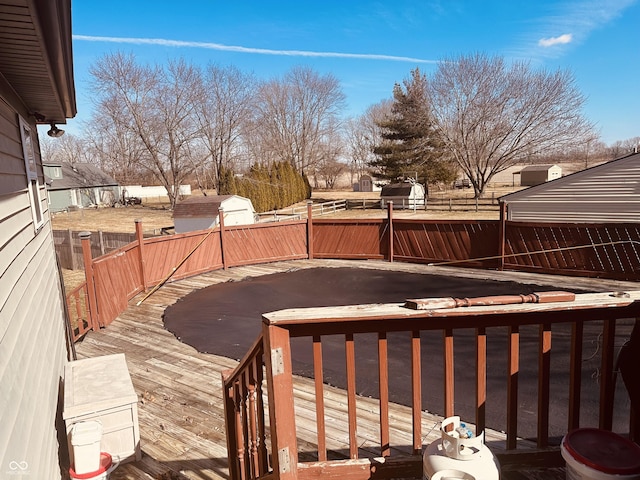 wooden terrace featuring a fenced backyard