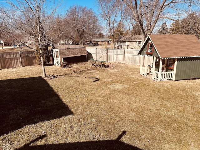 view of yard featuring an outbuilding and a fenced backyard