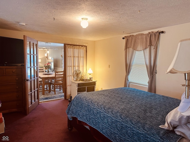 bedroom featuring a textured ceiling and carpet