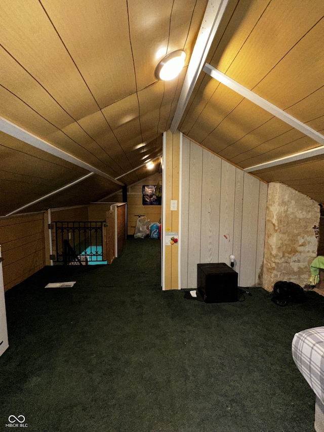 additional living space with carpet floors, wood ceiling, wooden walls, and lofted ceiling