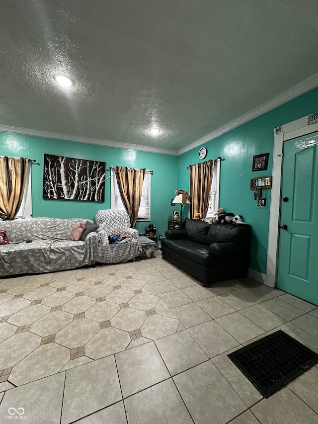 living area featuring a textured ceiling, ornamental molding, and light tile patterned floors