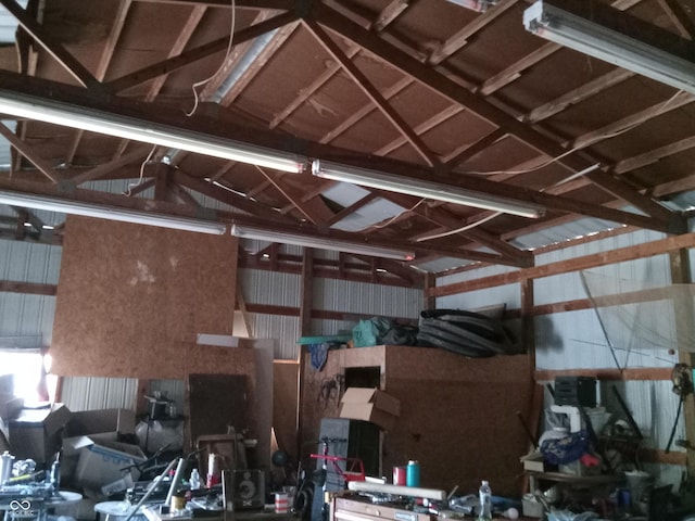 miscellaneous room featuring a garage and lofted ceiling