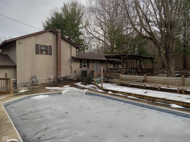 exterior space featuring a chimney, fence, and a deck