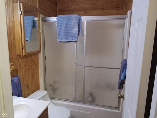 full bath featuring enclosed tub / shower combo, vanity, and toilet