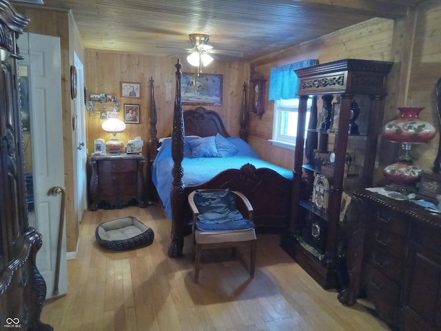 bedroom featuring wood ceiling, wood walls, and hardwood / wood-style flooring