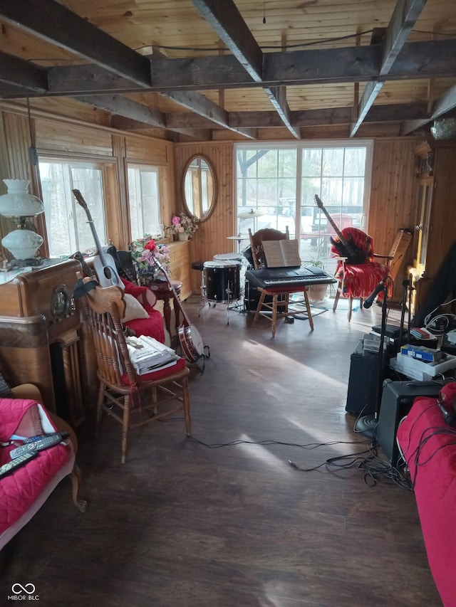 misc room with wood walls, beam ceiling, and wood finished floors