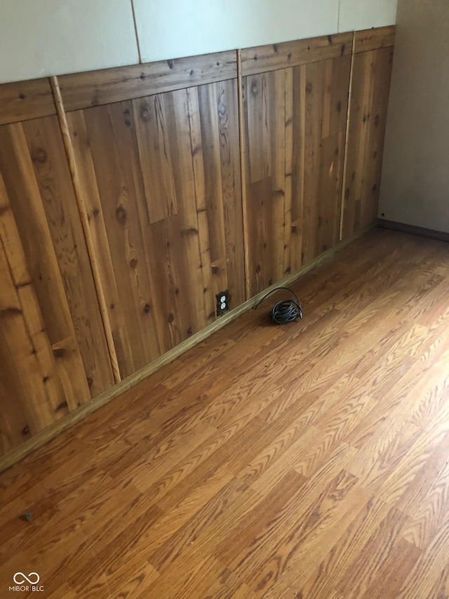 interior details with wood walls and wood finished floors