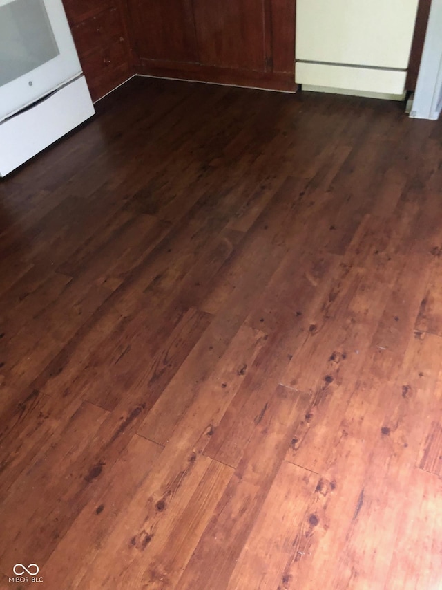 interior details with dark wood-type flooring and range