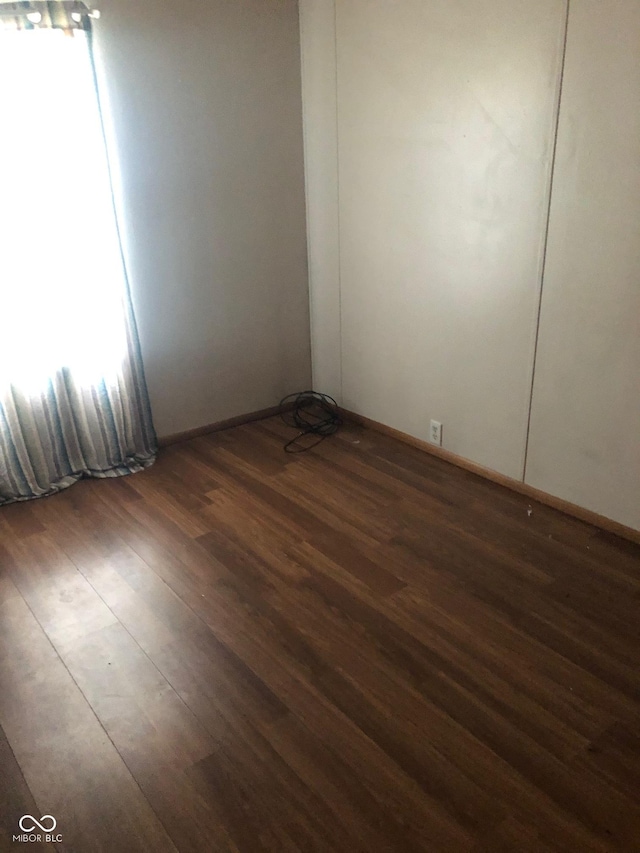 empty room featuring dark wood-type flooring