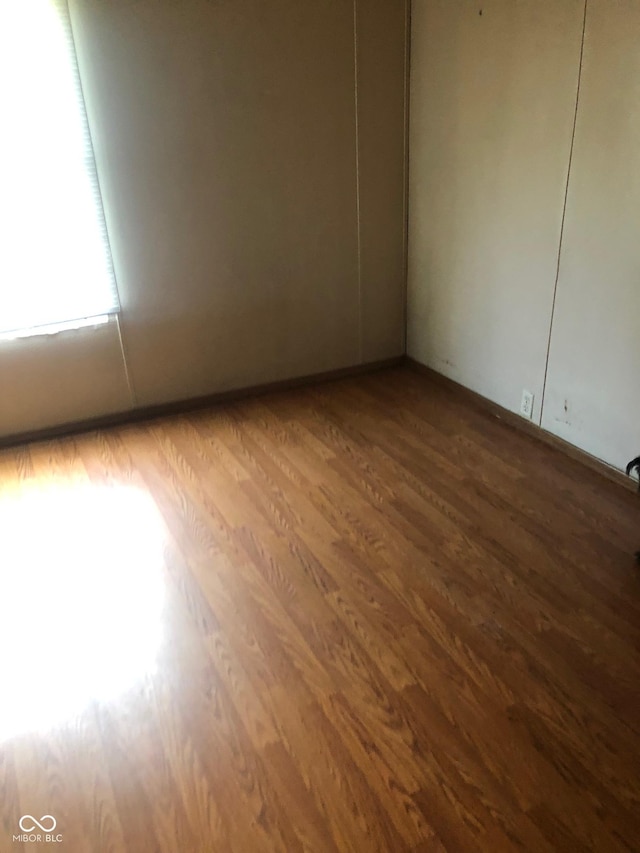 empty room with wood finished floors