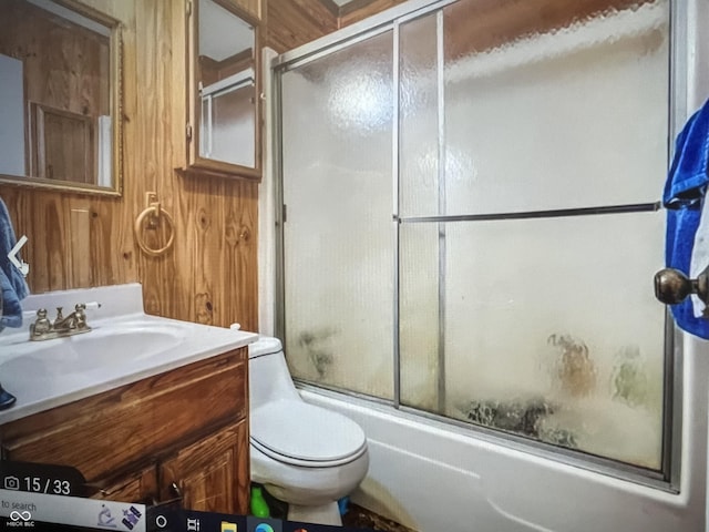 4005 Texas Pike, Spencer, IN 47460 - bathroom featuring vanity, toilet, bath / shower combo with glass door, and wooden walls