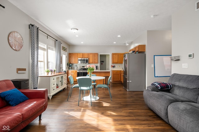 living room featuring visible vents, dark wood-style flooring, and recessed lighting