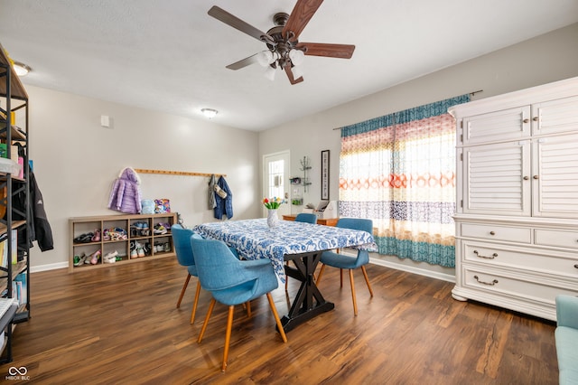 dining room featuring dark wood-style floors, ceiling fan, and baseboards