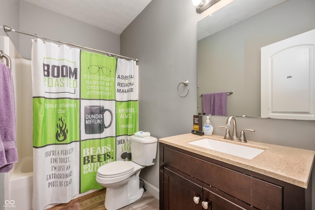 bathroom featuring toilet, wood finished floors, shower / bathtub combination with curtain, a textured ceiling, and vanity