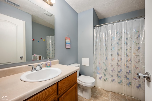 full bath with visible vents, toilet, vanity, a textured ceiling, and tile patterned flooring