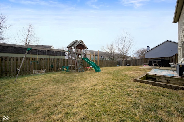 view of yard featuring a playground and a fenced backyard