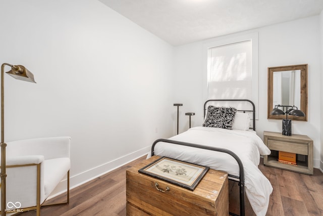 bedroom featuring wood finished floors and baseboards