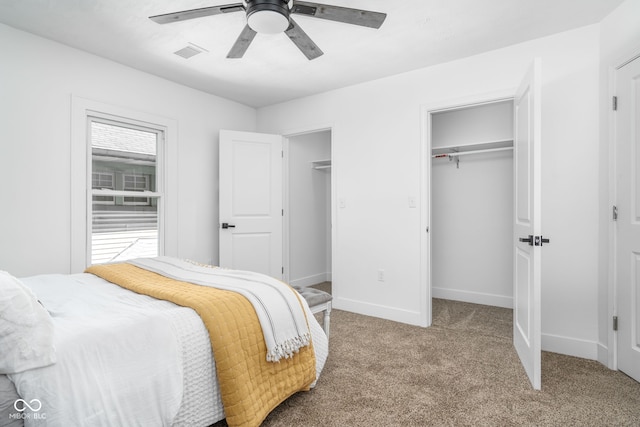 bedroom featuring carpet, a closet, visible vents, ceiling fan, and baseboards