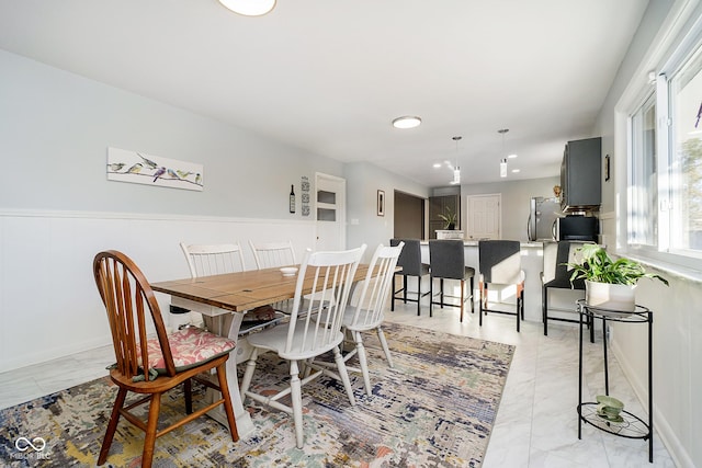 dining space with marble finish floor