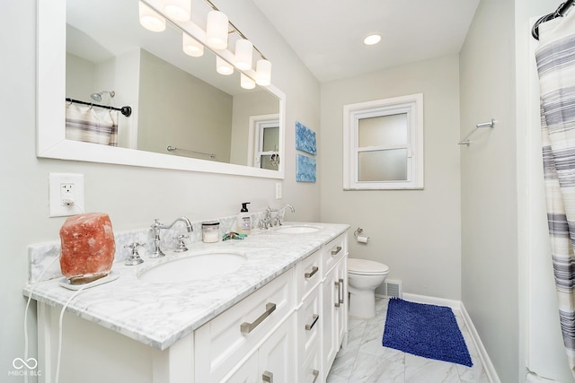 full bathroom featuring double vanity, a sink, visible vents, and baseboards