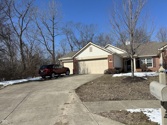 view of front facade featuring a garage, brick siding, and driveway