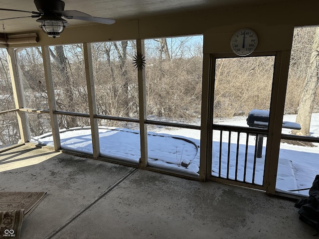 unfurnished sunroom featuring ceiling fan