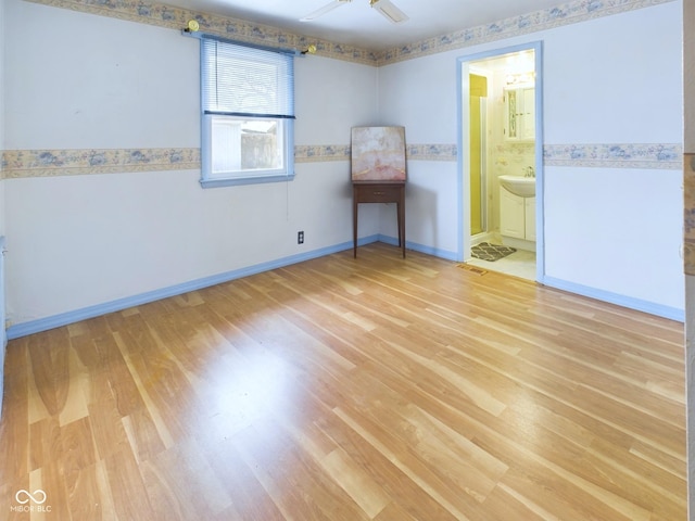 empty room with visible vents, light wood-style flooring, and baseboards