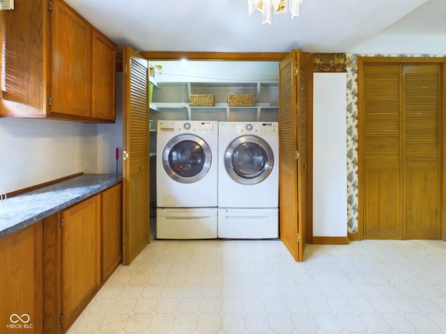 clothes washing area featuring laundry area, light floors, and washer and dryer