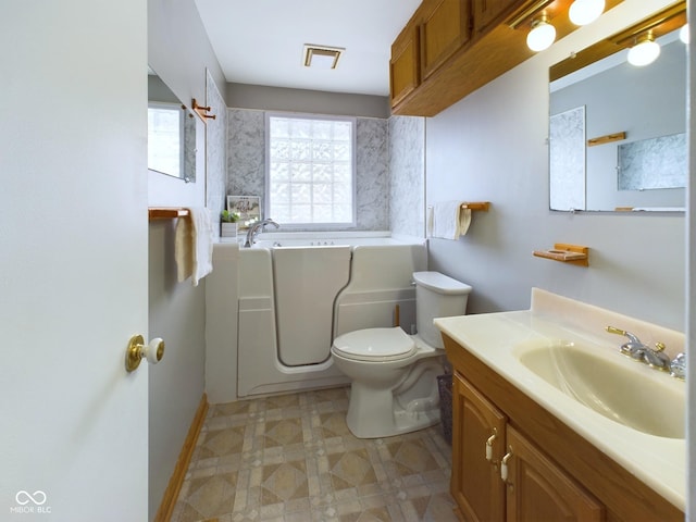 bathroom with toilet, tile patterned floors, a bath, and vanity