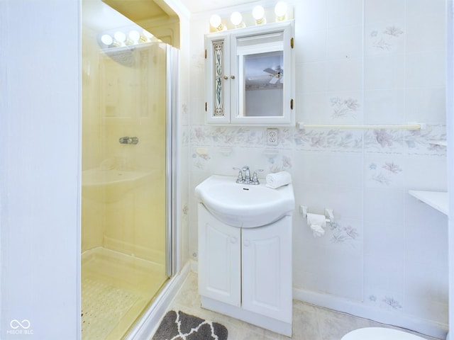 bathroom with a shower stall and vanity