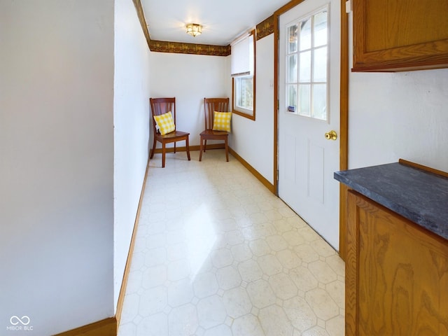 entryway featuring light floors and baseboards