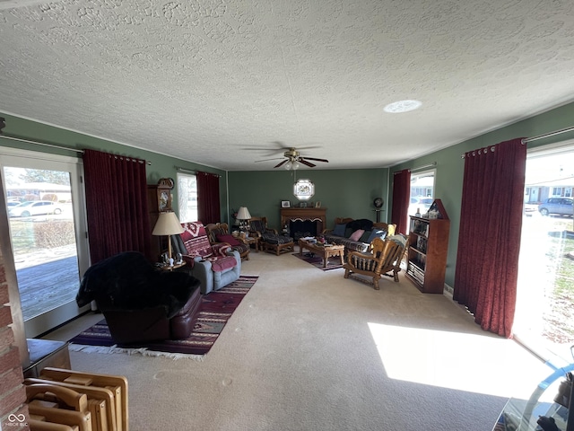 living area with a wealth of natural light, carpet flooring, and a fireplace