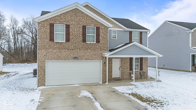 view of front of house featuring a garage, cooling unit, concrete driveway, and brick siding