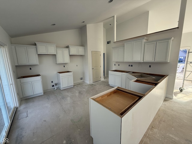 kitchen featuring high vaulted ceiling and a center island