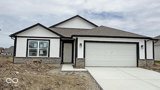 1414 Bluebonnet Pl, Shelbyville, IN 46176 - view of front of house with an attached garage, concrete driveway, roof with shingles, and stone siding