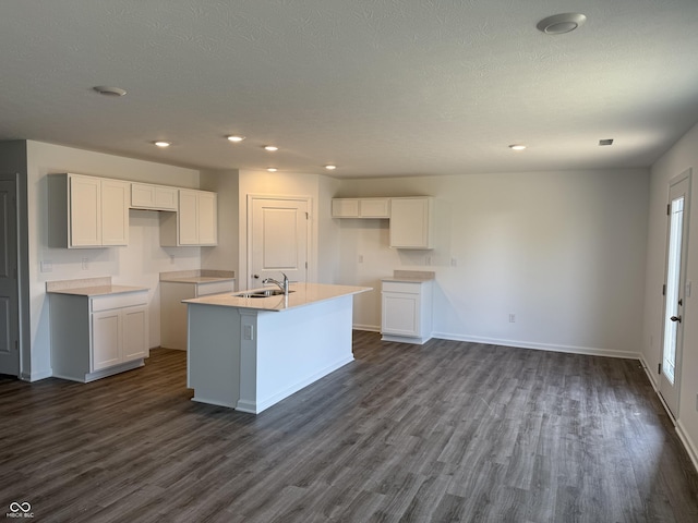 1414 Bluebonnet Pl, Shelbyville, IN 46176 - kitchen with dark wood-style floors, a kitchen island with sink, white cabinetry, recessed lighting, and a textured ceiling