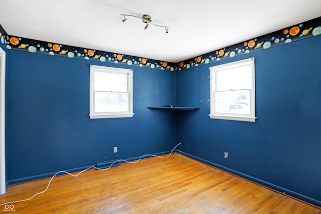 empty room featuring baseboards and wood finished floors