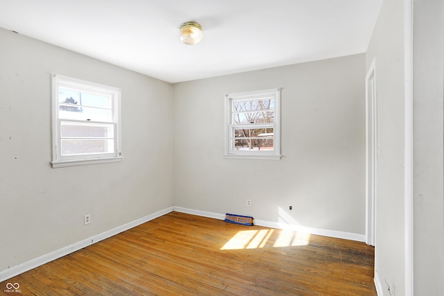 unfurnished room featuring baseboards and wood finished floors